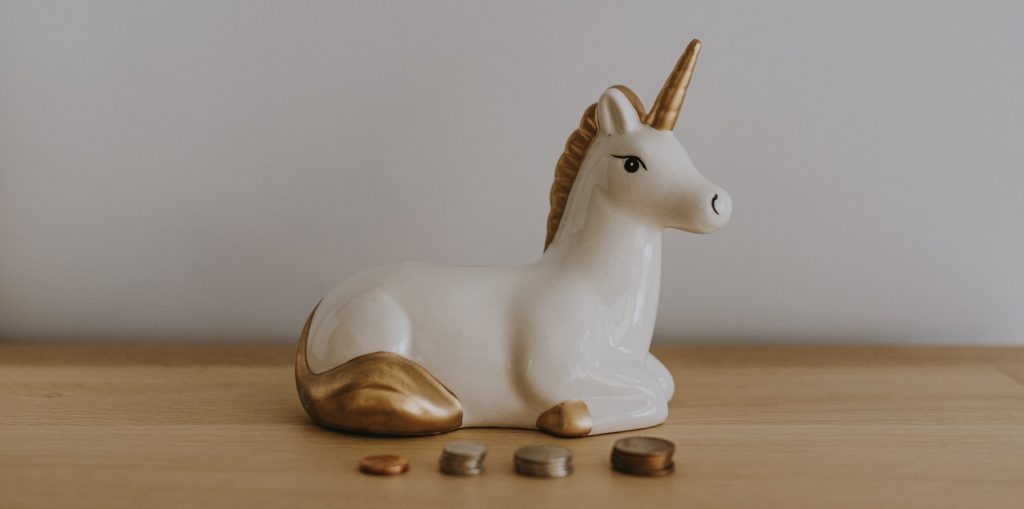 Unicorn money box with coins