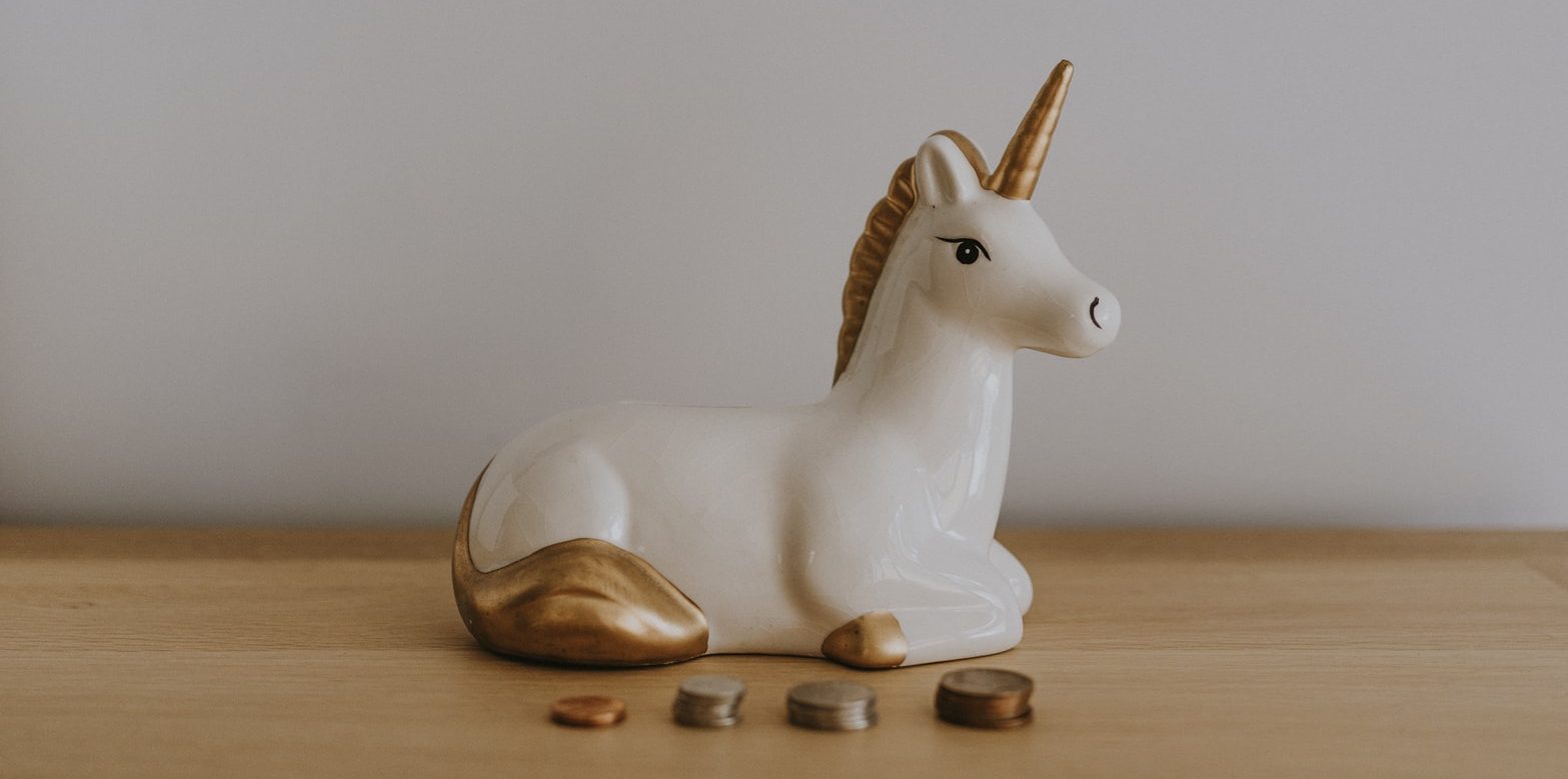 Unicorn money box with coins