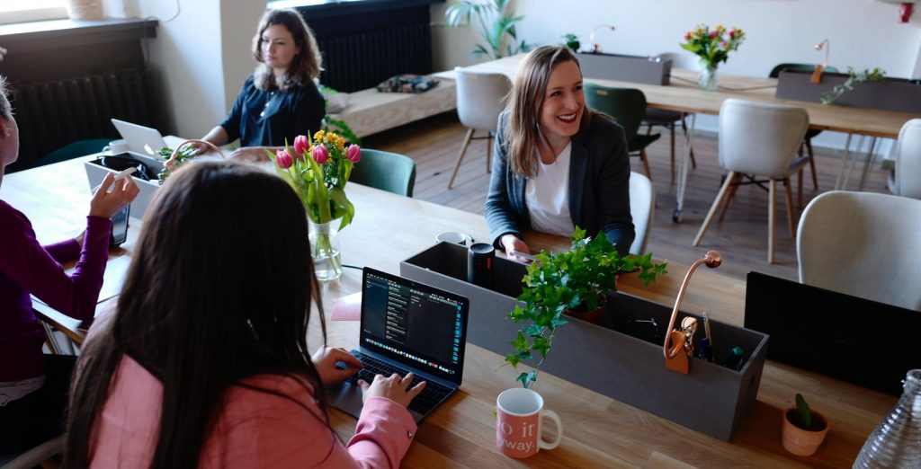 Women working and smiling at a table